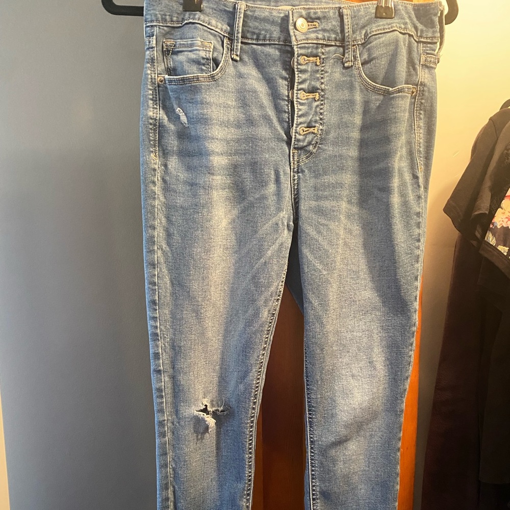 Distressed skinny leg high wasted button up jeans